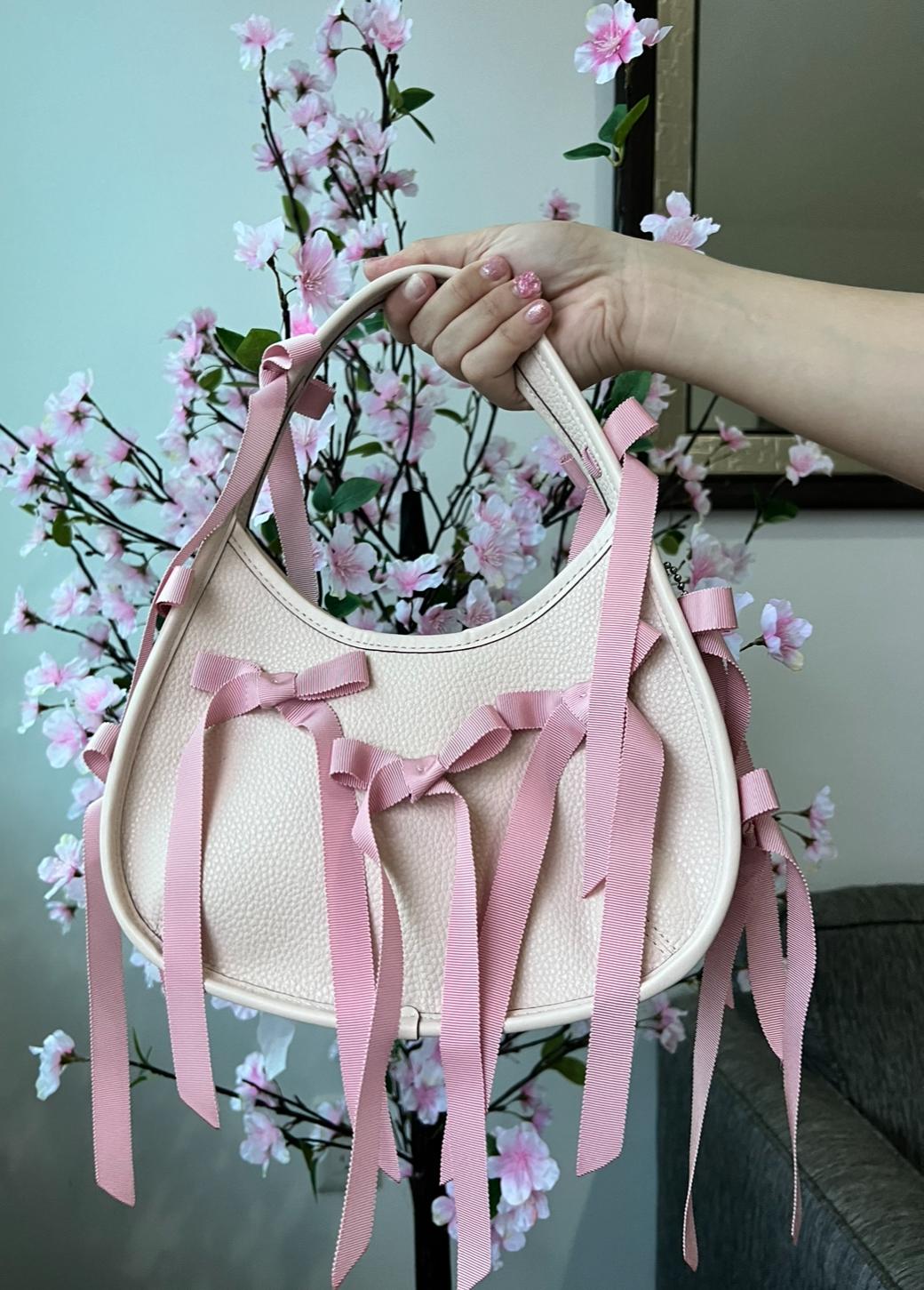 Ergo Bag Coachtopia de Piel con Moños Rosas